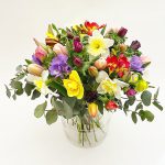 Colorful mixed spring bouquet with glass vase